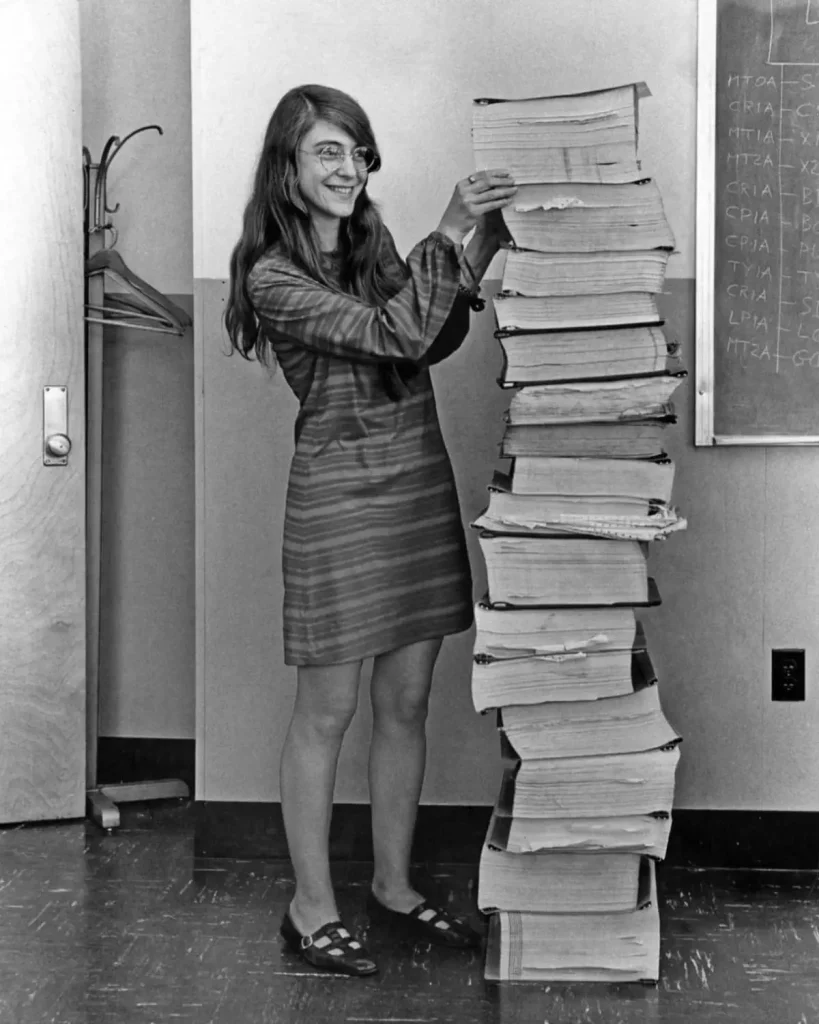 Margaret Hamilton in 1969, when she was the lead software engineer of the Apollo Project. She is standing next to a huge stack of code she and her MIT team produced for the Apollo project.