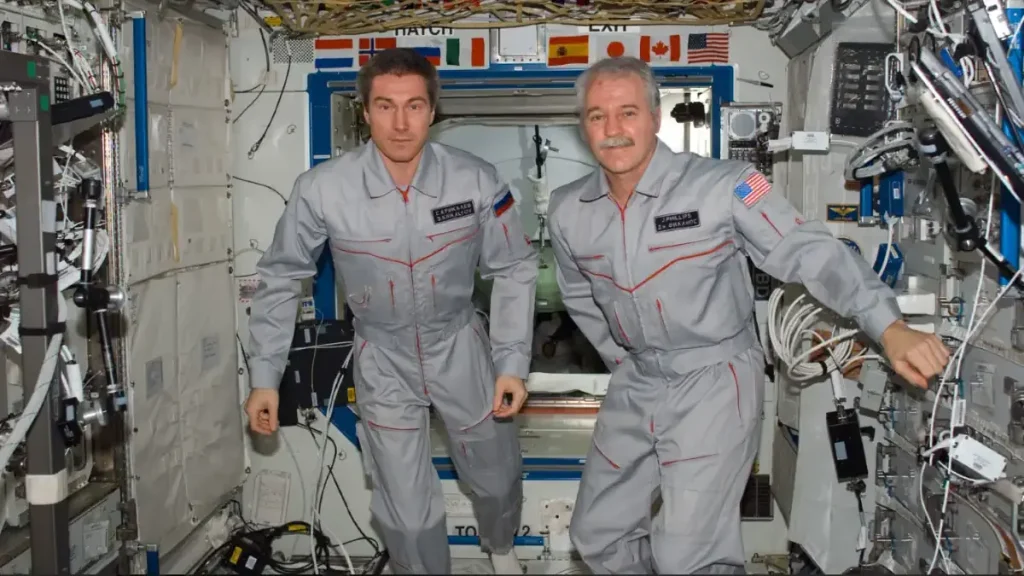 Cosmonaut Sergei K. Krikalev (left), Expedition 11 commander representing Russia's Federal Space Agency, and astronaut John L. Phillips, NASA Space Station science officer, and flight engineer, pose for a crew photo in the Destiny laboratory of the International Space Station